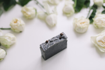 Fototapeta na wymiar Handmade natural floral soap and roses on white background. Soap making. Soap bars. Spa, skin care. Natural Organic spa cosmetics on white table from above. flat lay, top view
