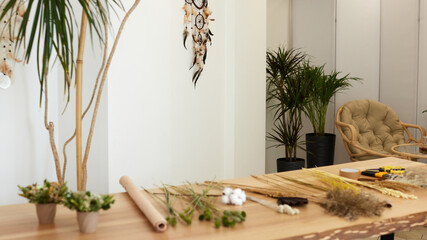 dried flowers and herbs on a table in a florist workshop