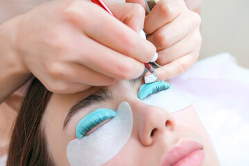 Young woman receiving eyelash lamination procedure in a beauty salon