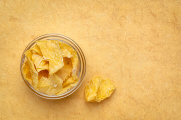 Bowl of dried slices of yacon tuber. Yacon contains inulin, a complex sugar, which promotes healthy probiotics. Superfood concept.