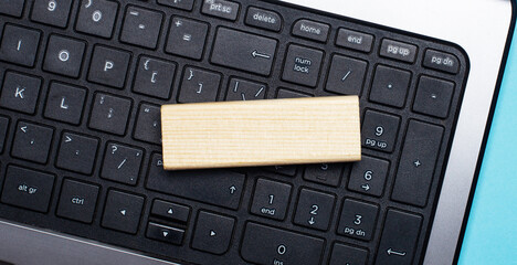 The computer keyboard has a light wood block with space to insert text. Template. Business concept