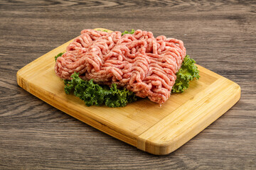 Raw pork minced meat over board