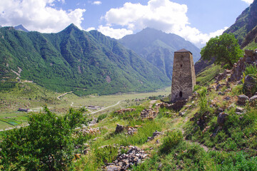 The burial tower of Abai-Kala on the background of an ancient abandoned village. Chegetskoe gorge
