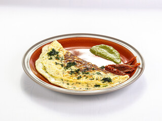 Omelet for breakfast served parsley