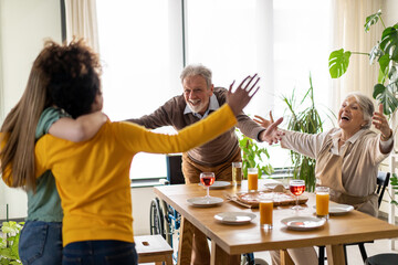 Grandparents welcoming multiethnic grandchildren. Extended multigenerational family together
