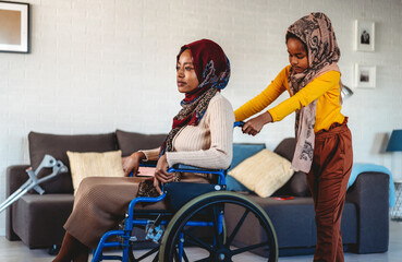Handicapped muslim mother with disability getting help from daughter