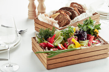 chopped fresh vegetables in a wooden box on a white background. Banquet festive dishes. Gourmet restaurant menu.