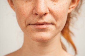 Obraz premium Close up photo of lower face of redhead young woman. Isolated over white background. Natural beauty and health