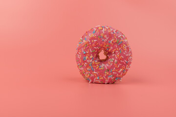 Fresh made Donuts isolated on pink background. Doughnuts are traditional sweet pastries. Copy space for text.
