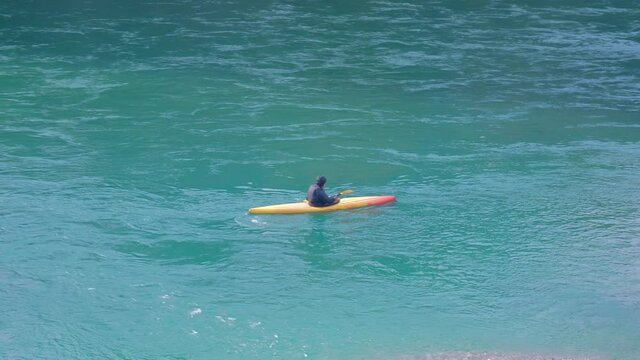 Old athlete man training on the kayak by the blue river in Montenegro, Podgorica. Sport lifestyle
