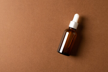 Serum bottle natural organic cosmetic on brown