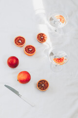 Red oranges and a drink. Minimal still life. 