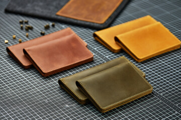 Set of handmade leather goods, key holder rings, wallet, purse, notepad, handbook. Handcrafted leather goods, close-up