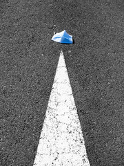 Face mask lying on asphalt