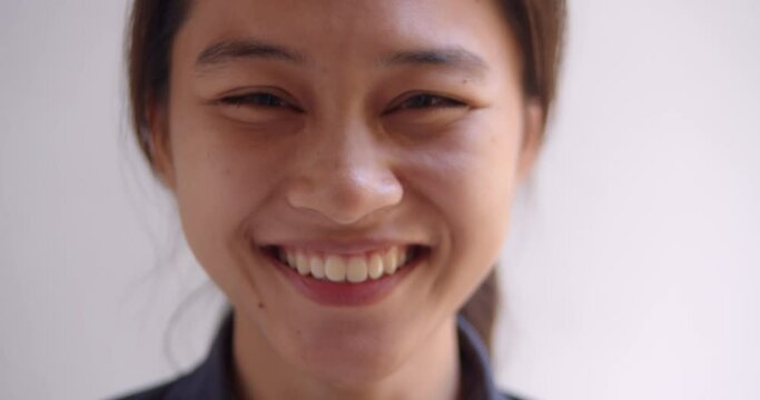 A female teenage Asian high school student girl is smiling happily. 