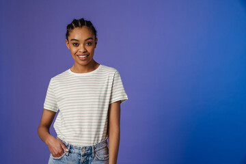 Young black woman in t-shirt smiling and looking at camera