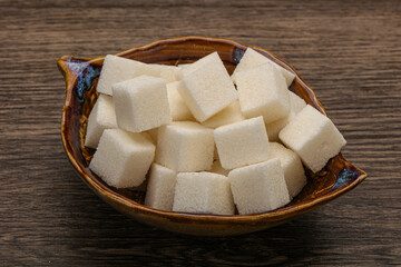 Refined white sugar cubs in the bowl
