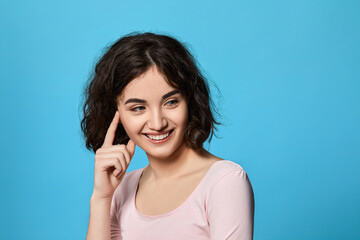 Fototapeta premium cute curly brunette woman thinking about something