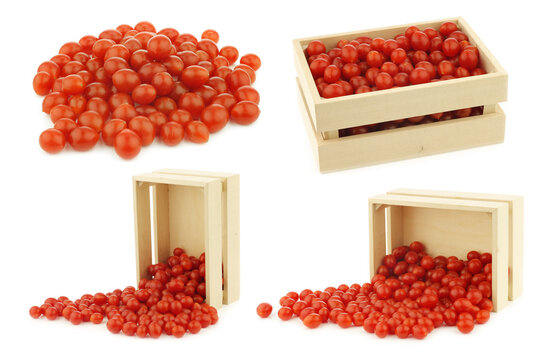 fresh Tomberry (very small) tomatoes in a wooden crate on a white background