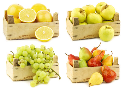 Fresh grapefruits, "Golden Delicious" apples, whit seedless grapes and mixed pears in a wooden crate on a white background