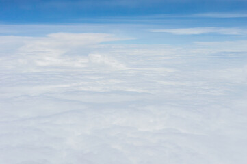 over the clouds,Blue sky with tiny clouds background Beautiful natural view from airplane window above. Background or Wallpaper.blue sky and cloud sky nature.Top view of aircraft