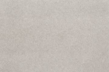 Uniform texture of a dense light cardboard sheet.
