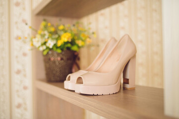 wedding shoes and flower basket on shelf