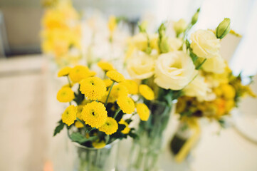 yellow flowers in vases