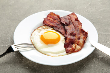 Eggs and bacon for breakfast on grey background. English breakfast