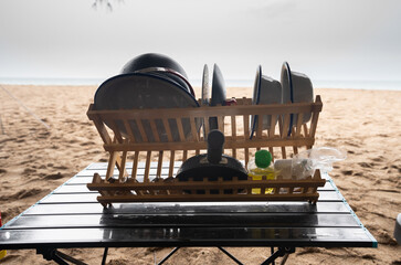 Kitchen equipment is placed on the shelf on the camping table, camping on a beach holiday.