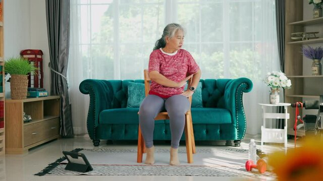 Senior woman Sit on chair to exercise arms and body