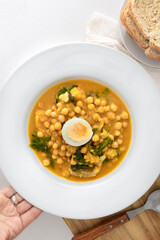 Traditional Spanish cuisine dish that is eaten mainly during the Holy Week holidays. Chickpea, cod, spinach and egg soup. Vigil Potaje.