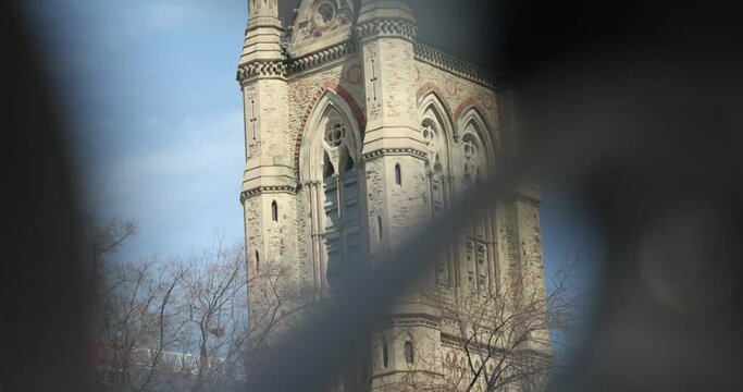 West Block Parliament building through the steel gate of the surrounding walls in Ottawa, Ontario.