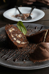 Woman eating brownie cake and whipped cream in the modern cafe. Dessert with cherries and mint.