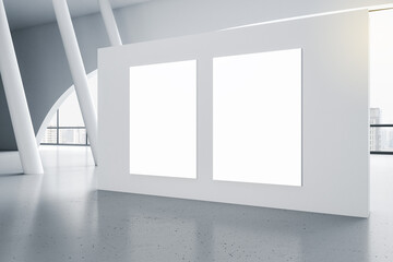 Gallery with a white wall with two blank white posters, concrete floor, panoramic windows, promotion concept, mockup