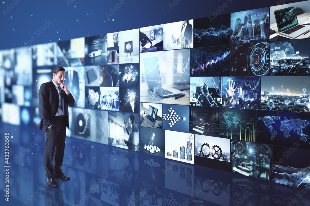 Poster Monitoring concept with businessman in studio with video archive on media wall.