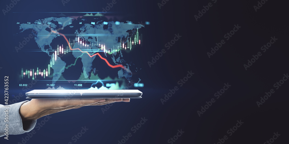 Poster World market trading concept with digital tablet on human hand and digital financial chart graphs and world map on dark background with copyspace. Mock up