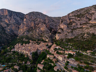an aerial view of a small town in France. Moustiers Sainte Marie in France is also called the Monk Town. 