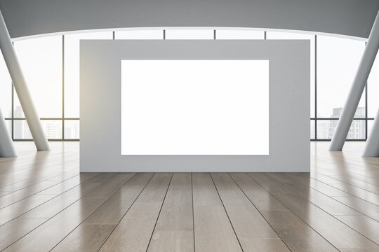 Blank white poster on grey partition in sunny spacious hall with wooden floor and city view. 3D rendering, mock up