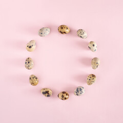 Easter background. Circle of eggs on pastel pink layout. Minimal holiday concept.