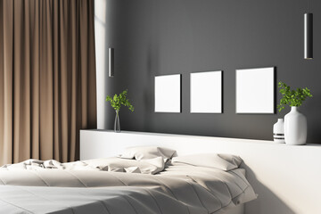 Bright empty bedroom with three blank white posters on the black wall, flowers in the flowerpots, white linen, curtains, interior design concept