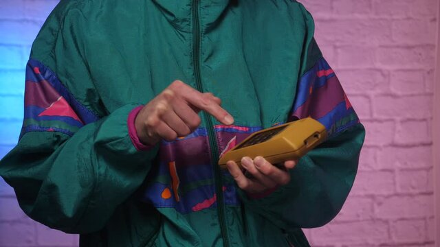 Calculating using a retro vintage portable calculator in the 80s 90s.