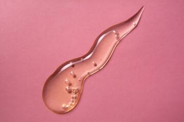 Cosmetic gel product on pink background. Texture and background