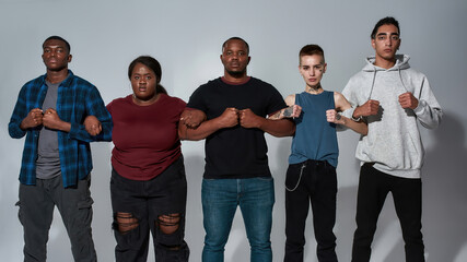 Young crowd standing side by side holding hands