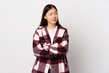 Young Chinese girl over isolated white background looking to the side