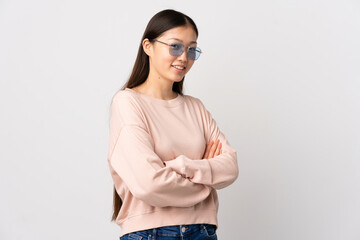 Young Chinese girl over isolated white background with arms crossed and looking forward