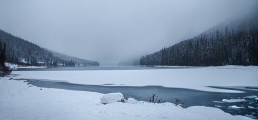 PP19-012 Frozen lake framed by pine trees  in Pemberton BC.