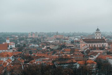 Naklejka na ściany i meble Panoramic view of the Vilnius old town during cloudy and gloomy winter day
