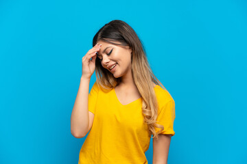 Young Russian girl isolated on blue background laughing