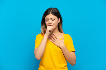 Young Russian girl isolated on blue background coughing a lot